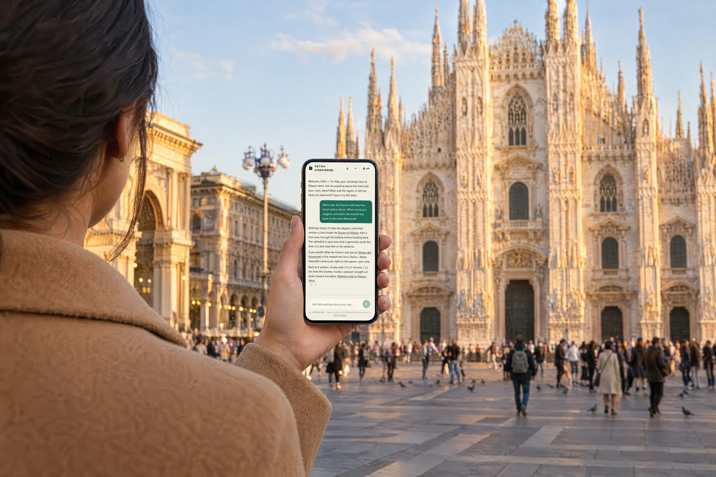 A guest in Piazza del Duomo in Milan holding a phone that shows a real answer from the property’s concierge.