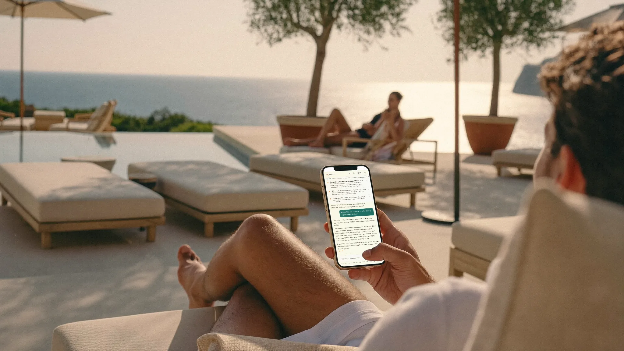 Guests relaxing by the pool at a sun-drenched resort, the concierge a tap away