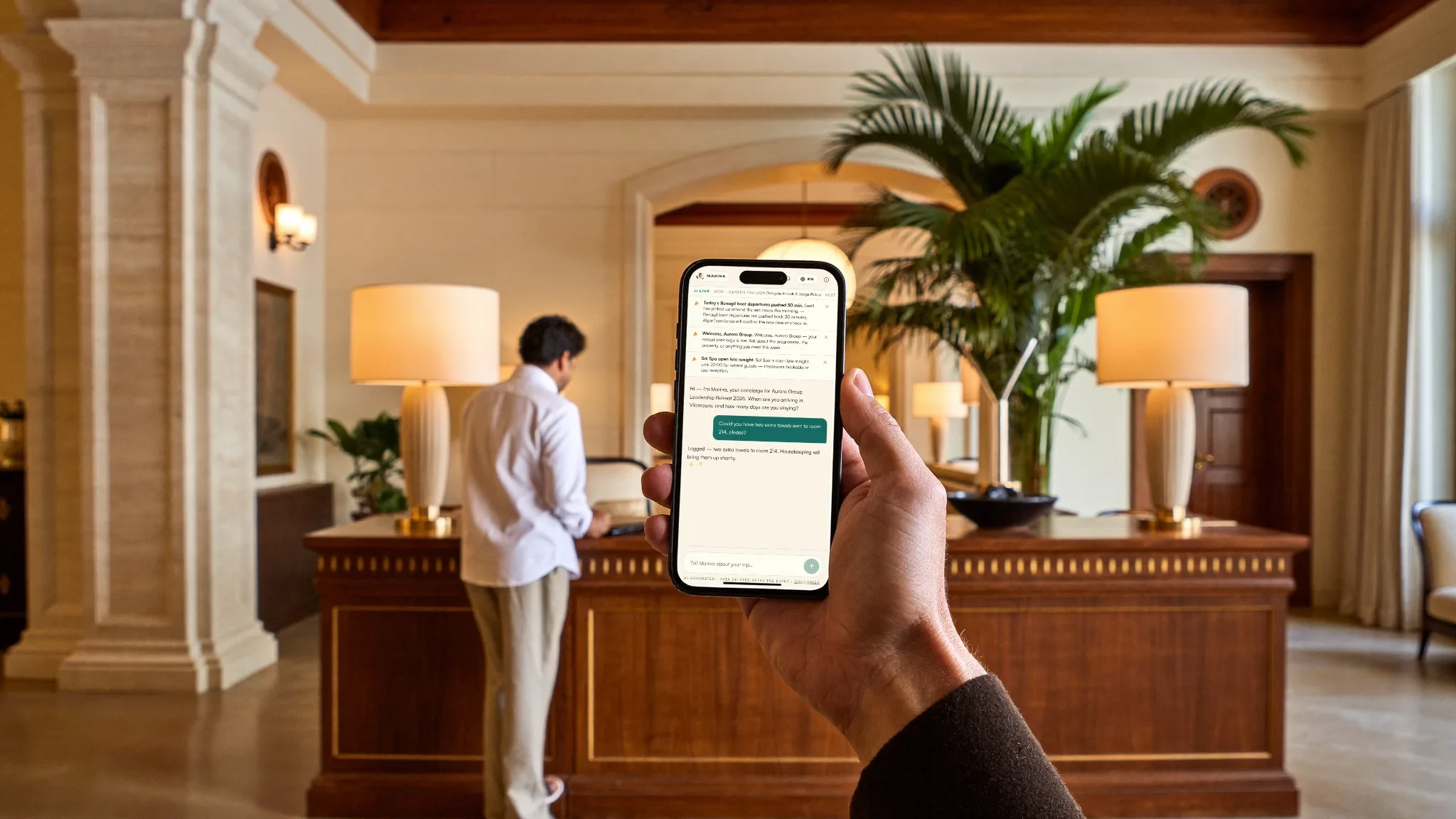 A guest at a warm five-star hotel concierge desk, the concierge on their phone